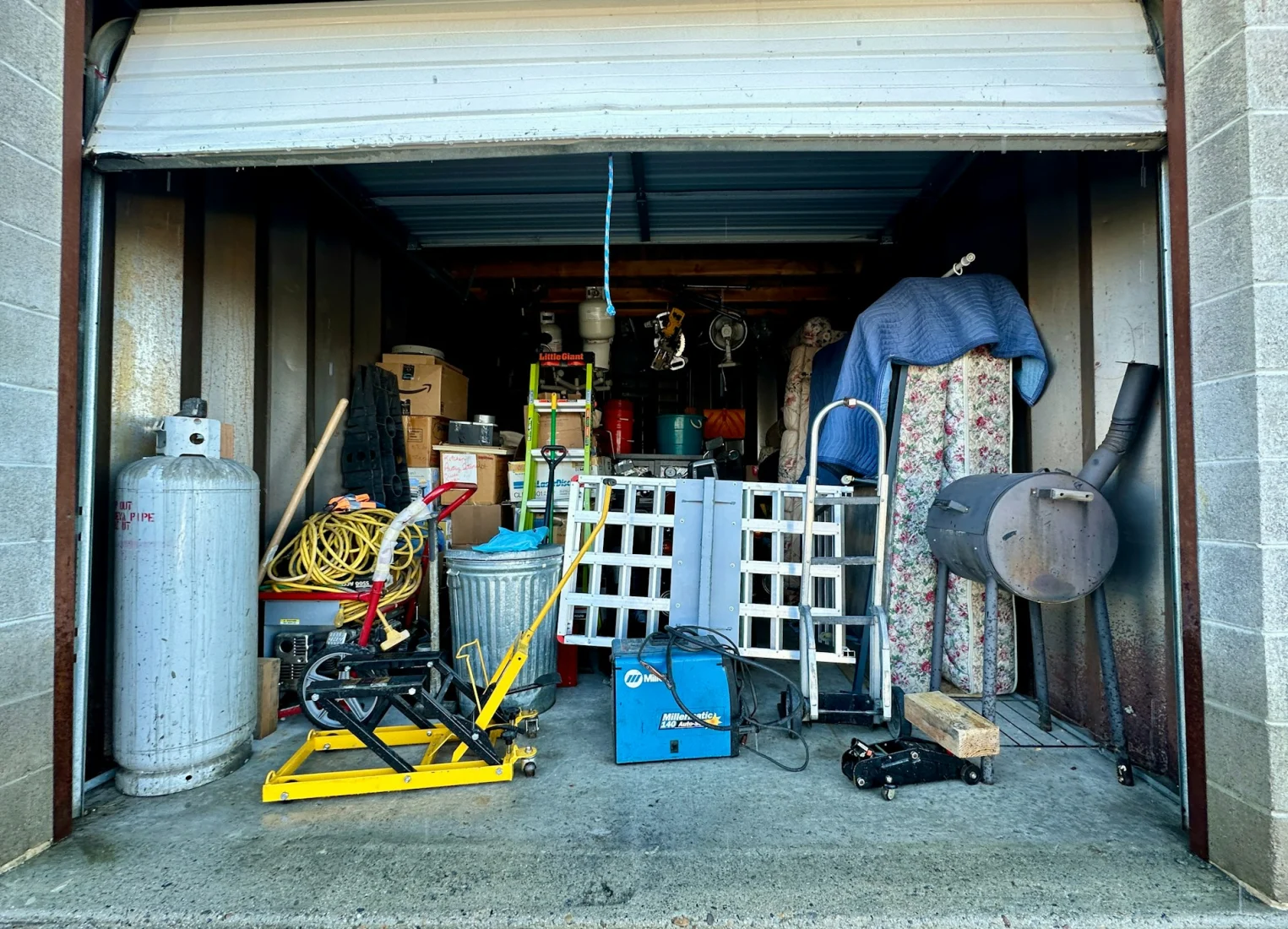 Garage filled with clutter before a junk removal cleanout