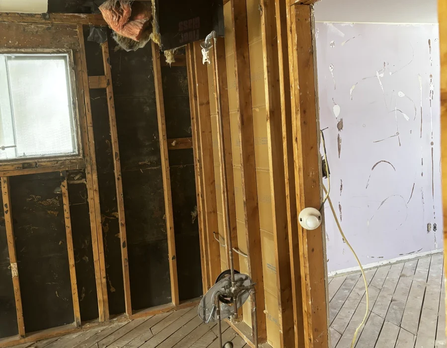 Wall opened to the framing with the ductwork exposed