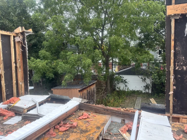 Upper floor walls removed, with debris on the floor deck